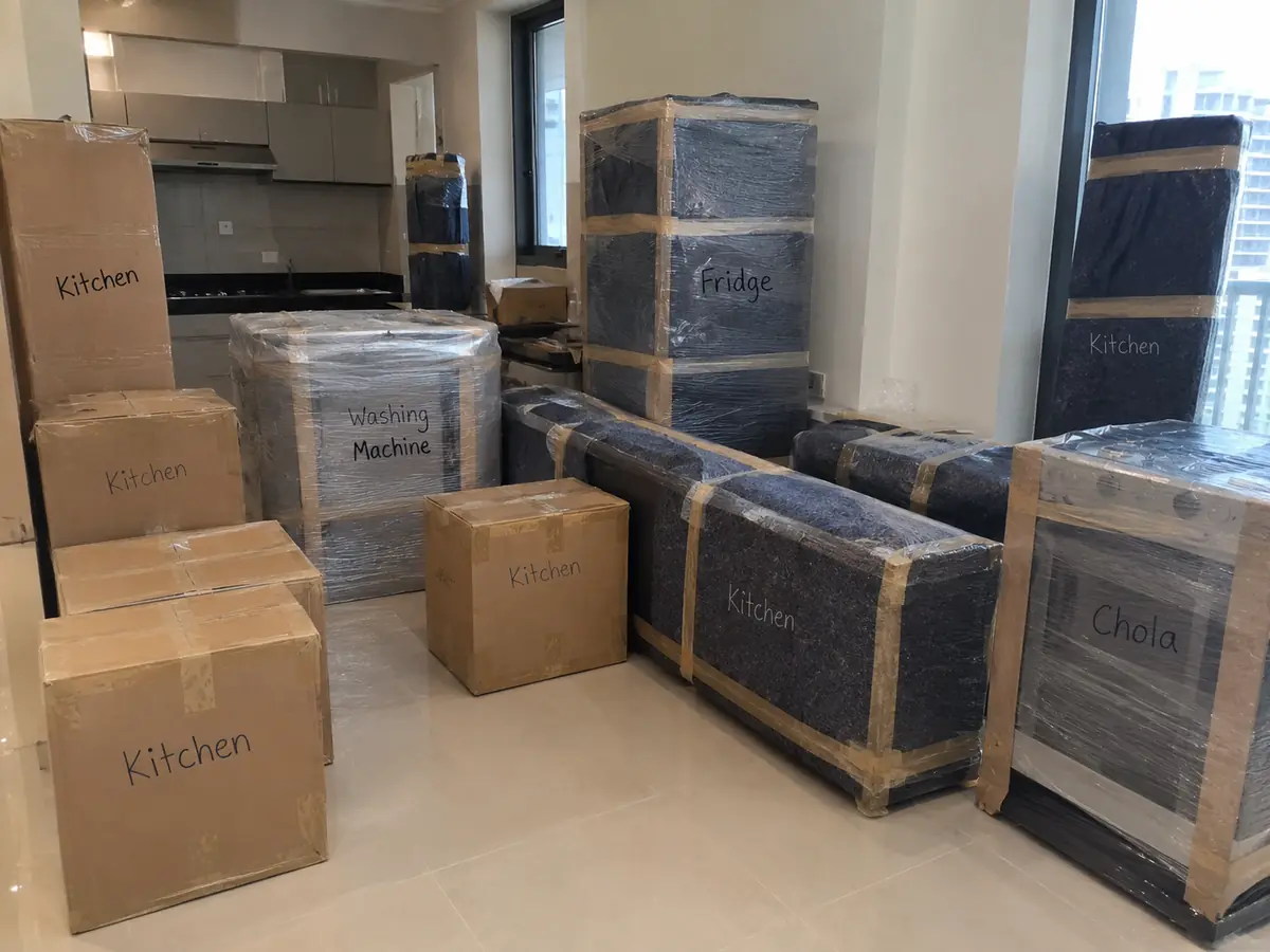 Kitchen appliances and boxes wrapped and labelled for moving